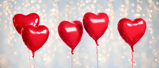 Image showing five red heart shaped helium balloons on white