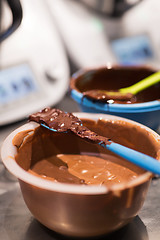 Image showing chocolate cream in bowl at confectionery shop