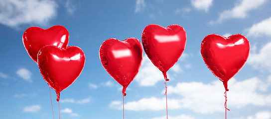 Image showing five red heart shaped helium balloons on white