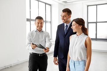 Image showing realtor showing tablet pc to customers at office