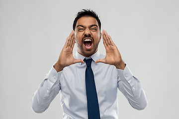 Image showing indian businessman screaming over grey