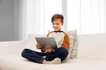 Image showing smiling boy with tablet pc computer at home