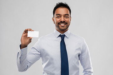 Image showing indian businessman with business card over grey