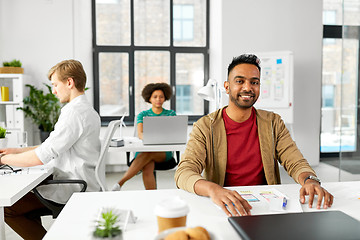 Image showing indian male creative worker with laptop at office