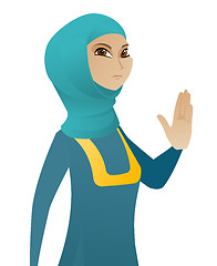 Image showing Young muslim business woman showing palm hand.