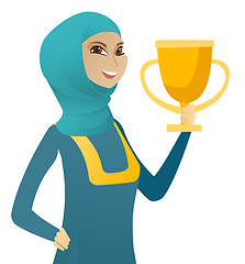 Image showing Young muslim business woman holding a trophy.