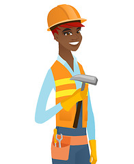 Image showing Young african-american carpenter holding a hammer.