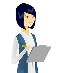 Image showing Young asian business woman writing on clipboard.