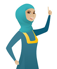 Image showing Young muslim business woman pointing her finger up