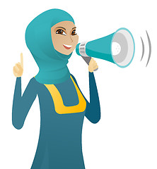 Image showing Muslim business woman speaking into loudspeaker.