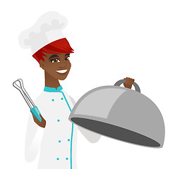 Image showing African chef cooking chicken on barbecue grill.