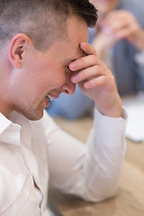 Image showing young businessman relaxing at the desk