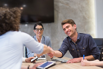 Image showing cloasing the deal in modern office interior