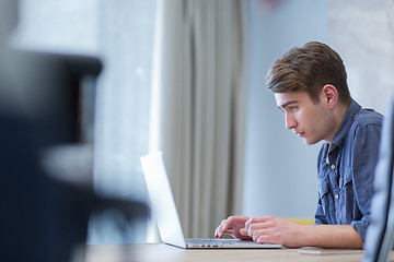 Image showing businessman working using a laptop in startup office