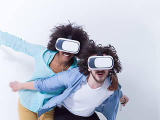 Image showing multiethnic couple getting experience using VR headset glasses