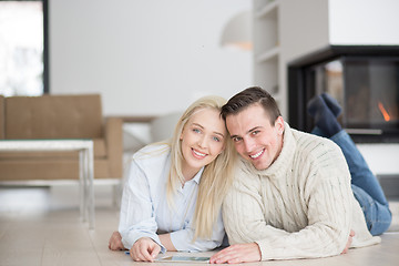 Image showing Young Couple using digital tablet on cold winter day