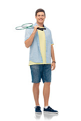 Image showing smiling young man with badminton rackets