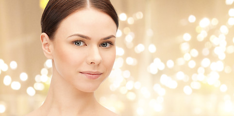 Image showing face of beautiful woman over lights background