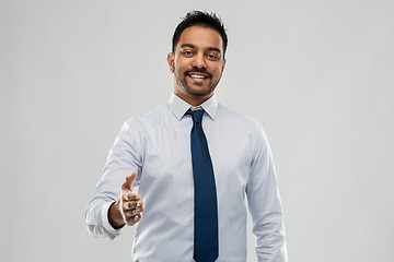 Image showing indian businessman stretching hand for handshake