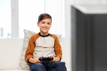 Image showing happy boy with gamepad playing video game at home