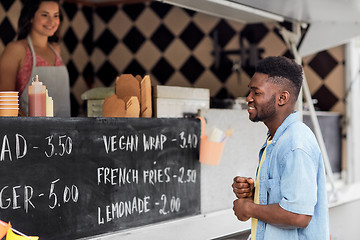 Image showing male customer looking at menu board at food truck