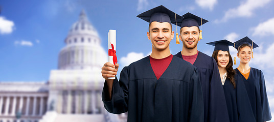 Image showing graduates in mortar boards with diploma