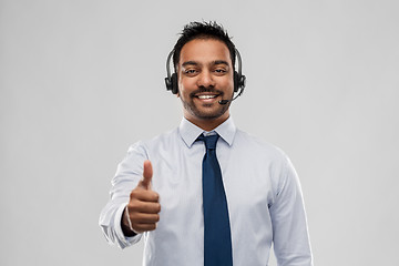 Image showing businessman or helpline operator showing thumbs up