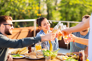 Image showing happy friends toasting drinks at rooftop party