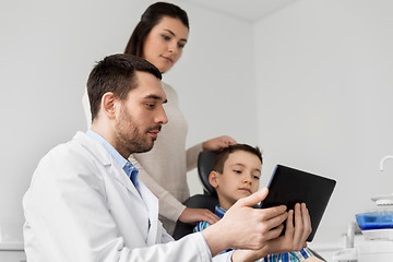 Image showing dentist showing tablet pc to kid at dental clinic