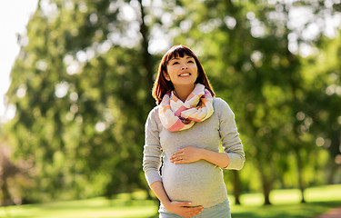 Image showing happy pregnant asian woman at park