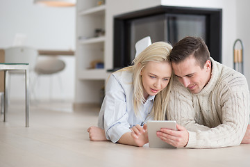 Image showing Young Couple using digital tablet on cold winter day