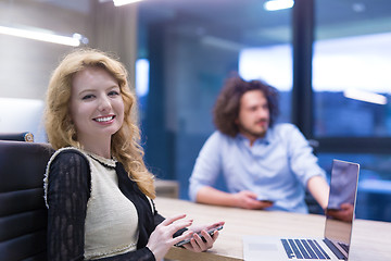 Image showing Elegant Woman Using Mobile Phone in startup office building