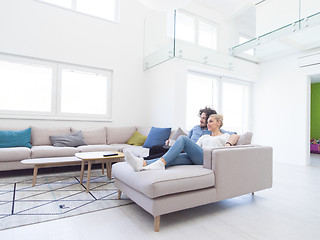 Image showing Young couple on the sofa watching television