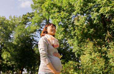 Image showing happy pregnant asian woman at park