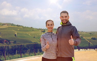 Image showing couple showing thumbs up over country landscape