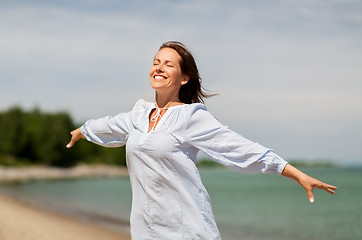 Image showing happy smiling woman on summer beach