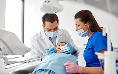 Image showing dentist checking for kid teeth at dental clinic