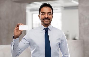 Image showing indian businessman with business card over office