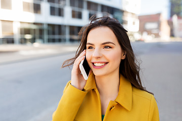 Image showing smiling young woman or girl calling on smartphone