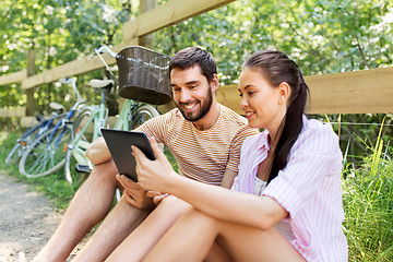 Image showing couple with tablet pc and bicycles at summer park