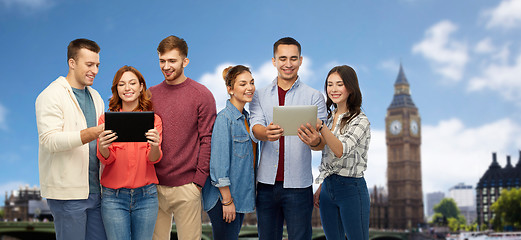 Image showing group of friends with tablet computers over london