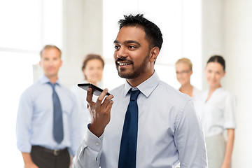 Image showing businessman using voice command on smartphone