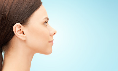 Image showing beautiful young woman face over blue background