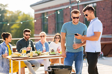 Image showing happy friends having bbq party on rooftop
