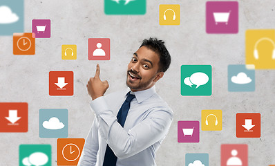 Image showing indian businessman pointing finger at app icons