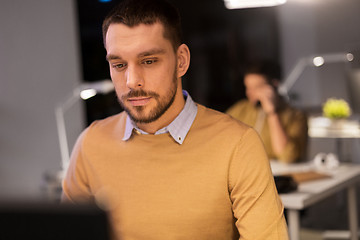 Image showing man with computer working late at night office