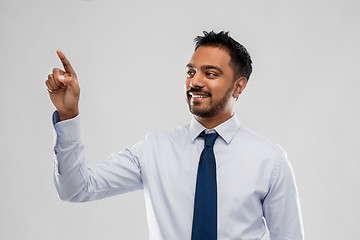 Image showing indian businessman touching something invisible