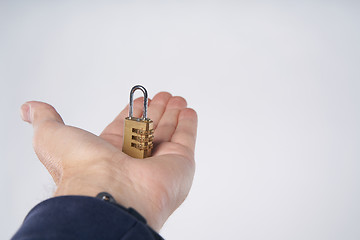 Image showing Man\'s hand holding small combination lock