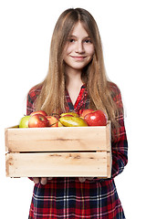 Image showing Teen girl with apples and pears in a box