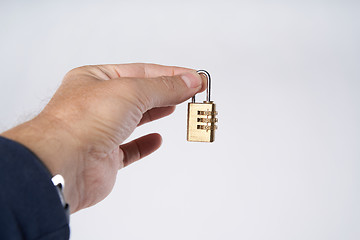 Image showing Man\'s hand holding small combination lock